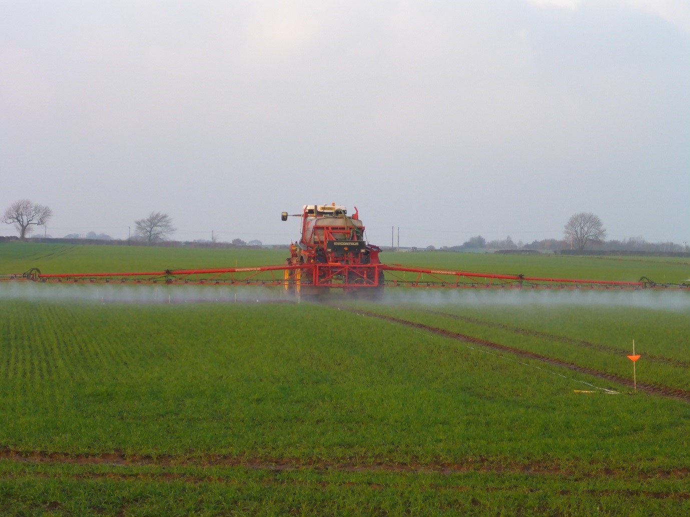 Tractor spraying herbicide onto a field 