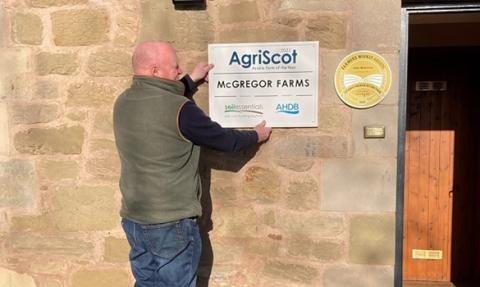 Farmer, Collin Mcgregor with his new sign