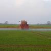 Tractor spraying herbicide onto a field 